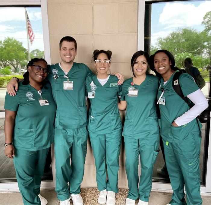 Nursing students stand together smiling